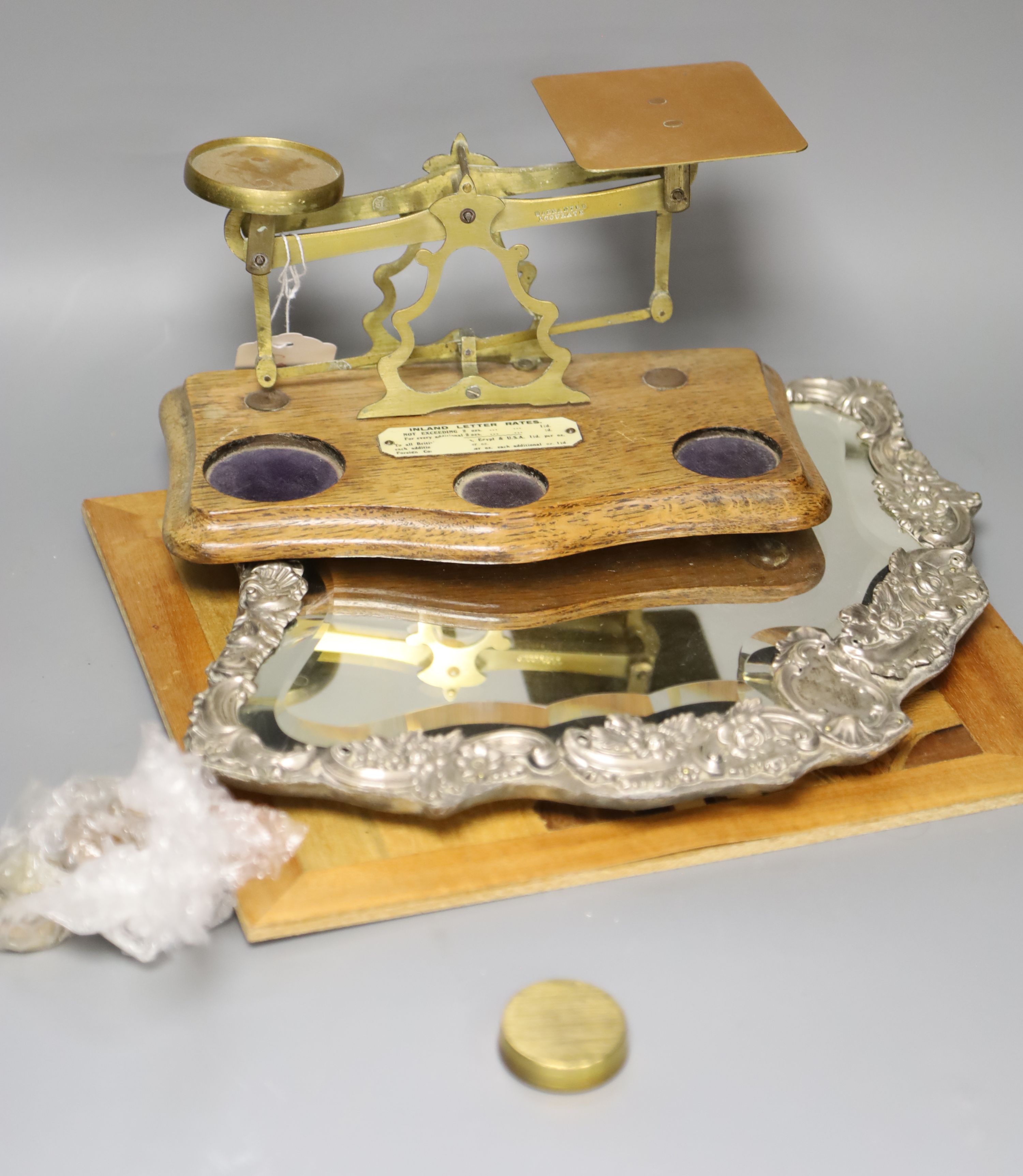 A set of postal scales, a silver overlaid easel mirror, length 36.5cm, and a carved wood panel